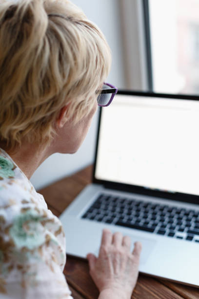 istock Back view of woman using laptop 671455650