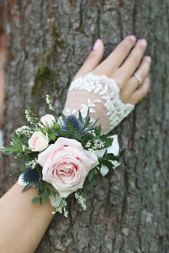 Pale pink, blue and green wrist corsage