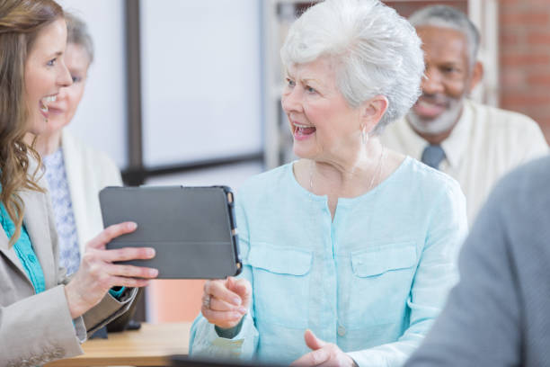 istock Cheerful woman uses tablet during seminar 671472898