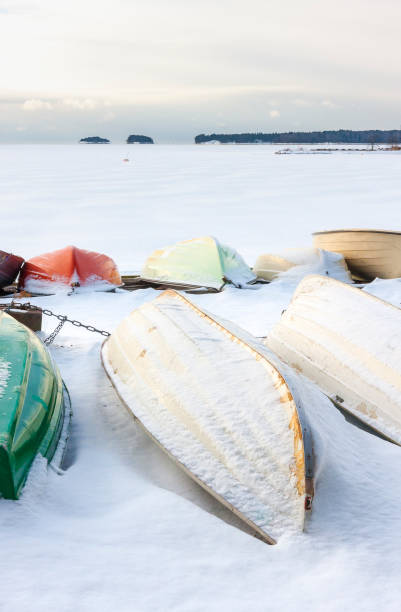 istock Snowy boat in harbor at winter 671476258