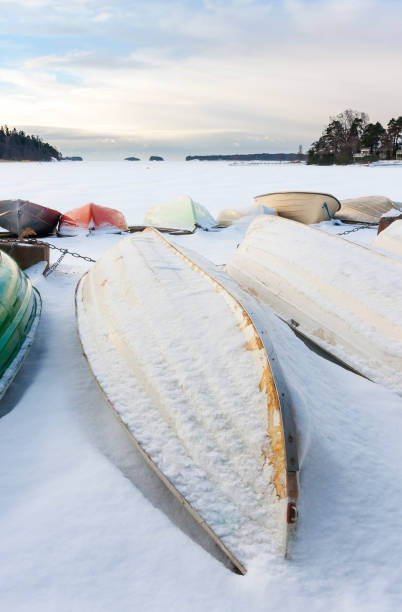 istock Snowy boat in harbor at winter 671476284