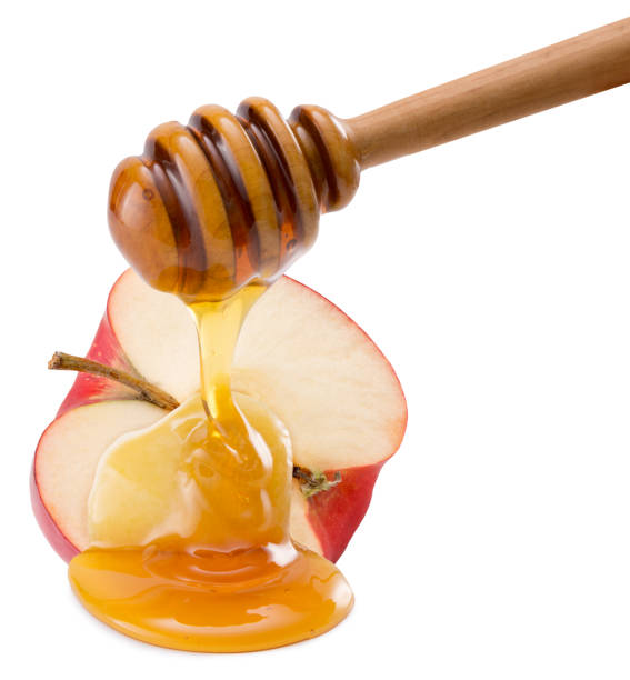 istock red apple with honey isolated on a white background 671479582