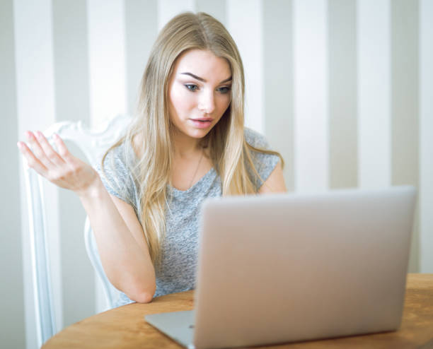 istock Beautiful young woman working with laptop 671494554