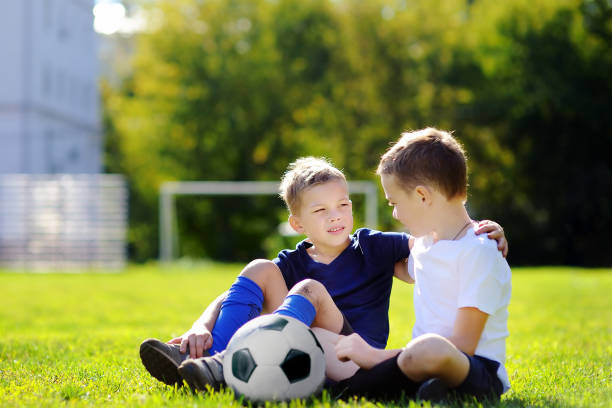 istock Two little boys playing a soccer game on sunny summer day 671499674