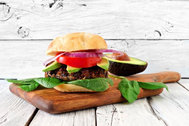 istock Bean and sweet potato veggie burger against rustic white wood 671500036