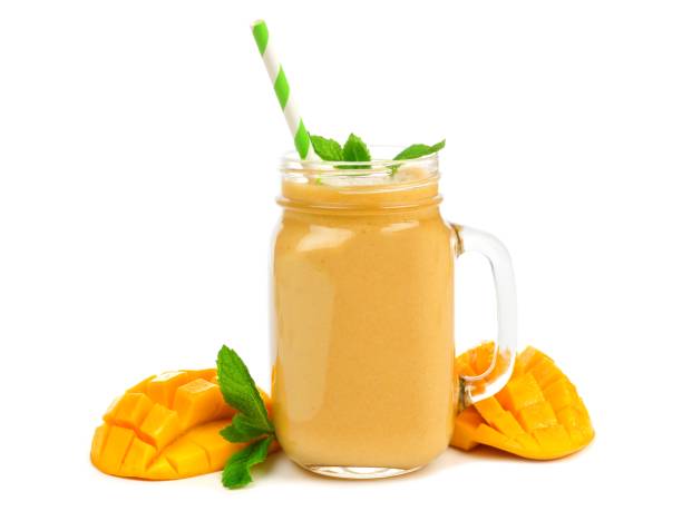 istock Mango coconut smoothie in a mason jar isolated on white 671500064