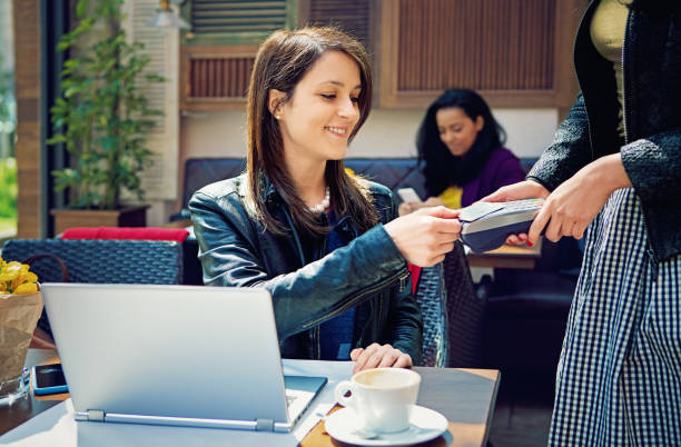 istock Girl is paying for her coffee using credit card in a cafeteria 671503416