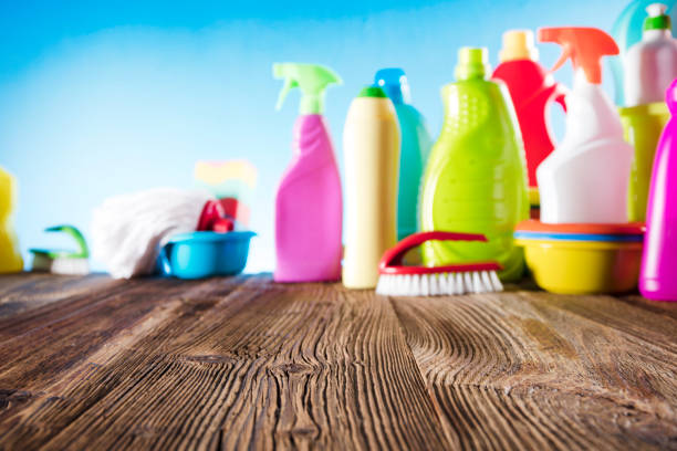 istock Rustic wooden table. House cleaning products in bokeh. 671503626