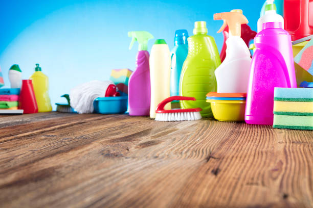 istock Rustic wooden table. House cleaning products in bokeh. 671503682