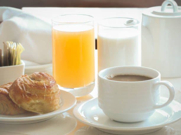 istock coffee, cinnamon roll, toast, milk and orange juice for breakfast. 671504048