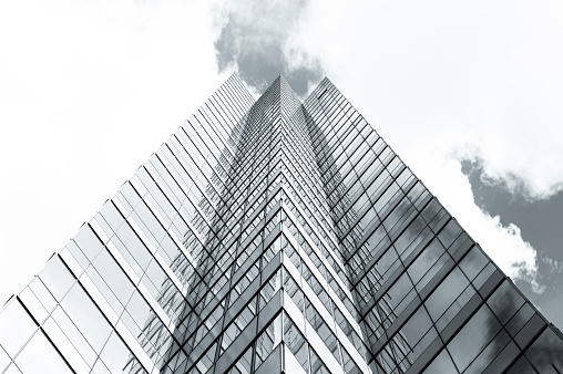 Black and white skyscraper, low angle view of office buildings, sky background with copy space, full frame horizontal composition
