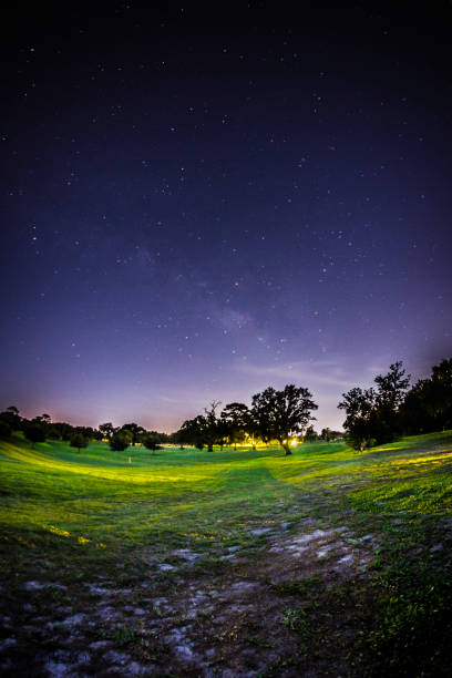 Faint Milky Way Milky Way in the sky, city lights, shot from a golf course. night golf stock pictures, royalty-free photos & images