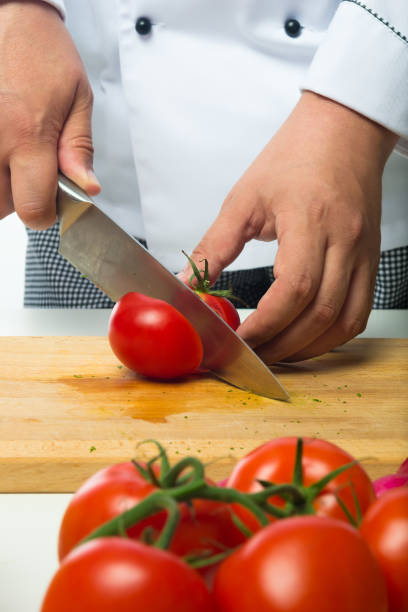 istock professional hands chopped tomatoes on a wooden board 671504200