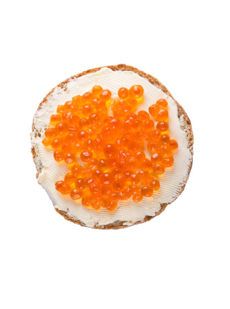 istock Round sandwich with butter and caviar on a white background 671504290