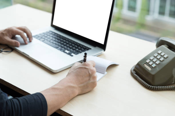 istock startup man using on a laptop, writing note while sitting the wooden table. concept of young people working with mobile device. 671504662