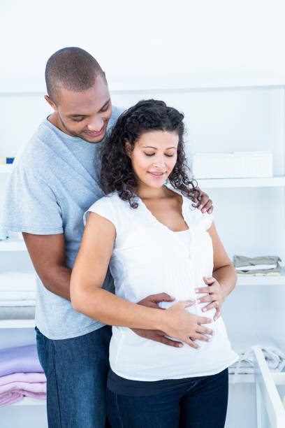 istock Husband touching pregnant wife belly 671505032