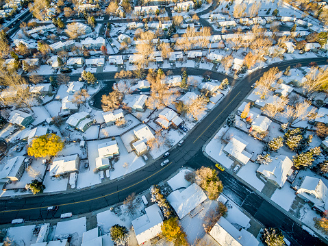 Fort Collins cityscape with fresh snow - aerial  view of typical residential neighborhood along Front Range of Rocky Mountains in Colorado, late winter  or early spring scenery