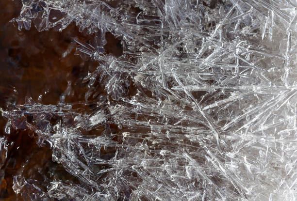 istock Ice crystals near the water. Natural background. Texture 671530126