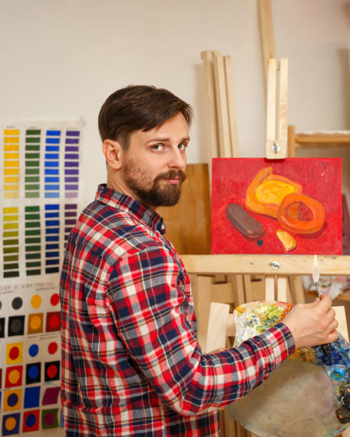 istock Artist with palette knife 671536510