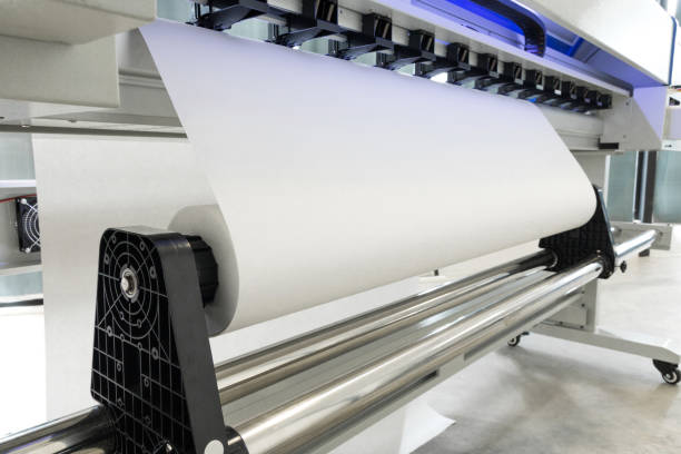 istock Paper roll in large printer format inkjet machine for industrial business. 671551038
