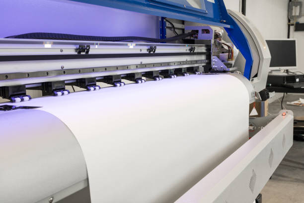 istock Paper roll in large printer format inkjet machine for industrial business. 671551362