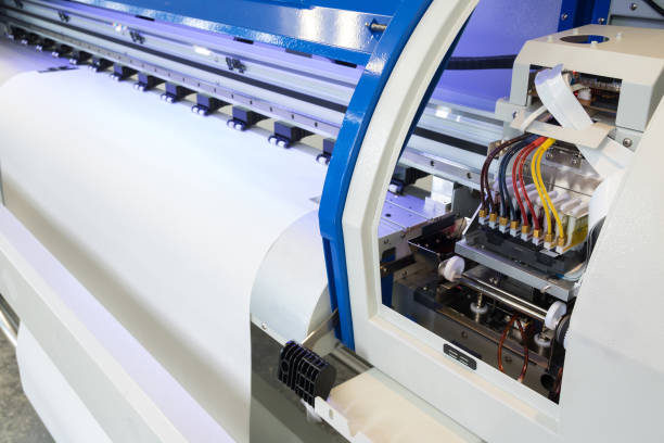 istock Paper roll in large printer format inkjet machine for industrial business. 671551418