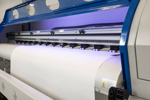 istock Paper roll in large printer format inkjet machine for industrial business. 671553716