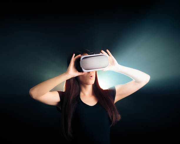 istock Woman with VR Glasses Headset Enjoying the Virtual Reality Experience 671556938