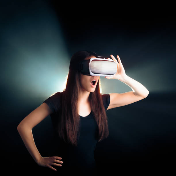istock Woman with VR Glasses Headset Enjoying the Virtual Reality Experience 671556946