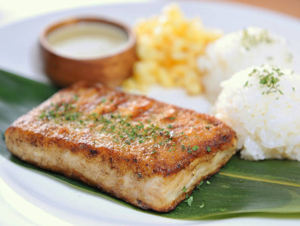 istock Platter of rice with fried fish fillet 671557268