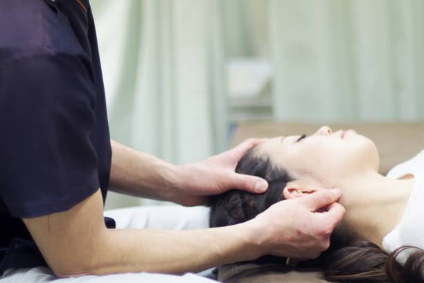 istock Woman receiving massage in ear 671564046