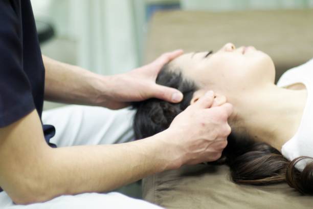 Woman receiving massage in ear