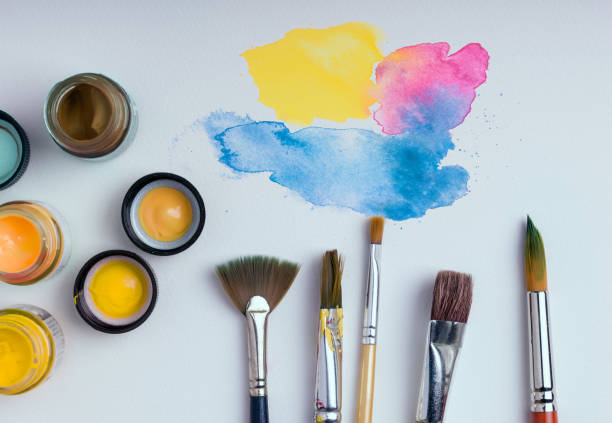 istock watercolor and brushes on white background 671564958