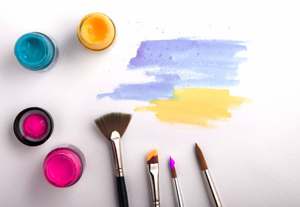 istock watercolor and brushes on white background 671565368