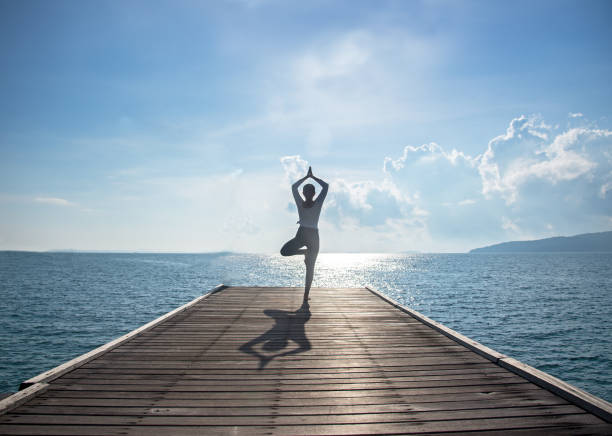 istock Caucasian woman practicing yoga at seashore 671568694