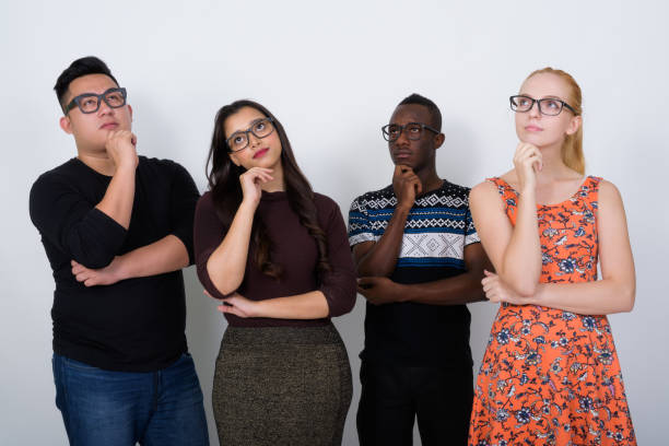 istock Studio shot of diverse group of multi ethnic friends thinking while looking up with eyeglasses together 671571436