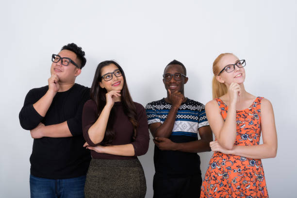 istock Studio shot of happy diverse group of multi ethnic friends smiling while thinking with eyeglasses together 671571594