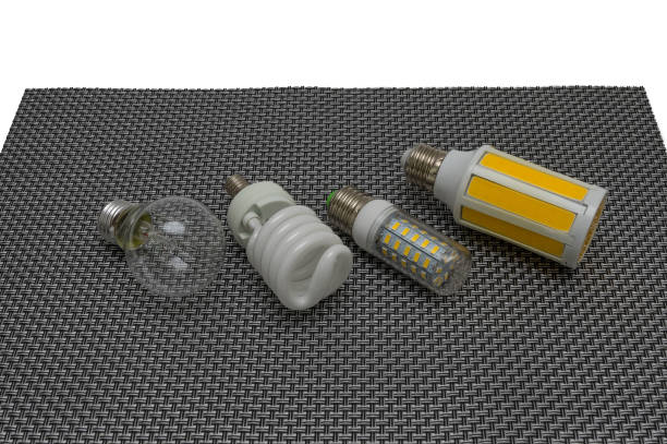 istock Four electric lamps on a dark background, a glow lamp, fluorescent, LED. 671578064