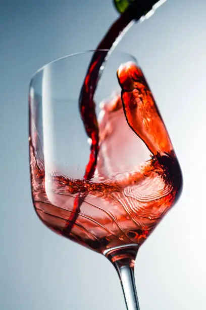 Photo of Red wine pouring in glass