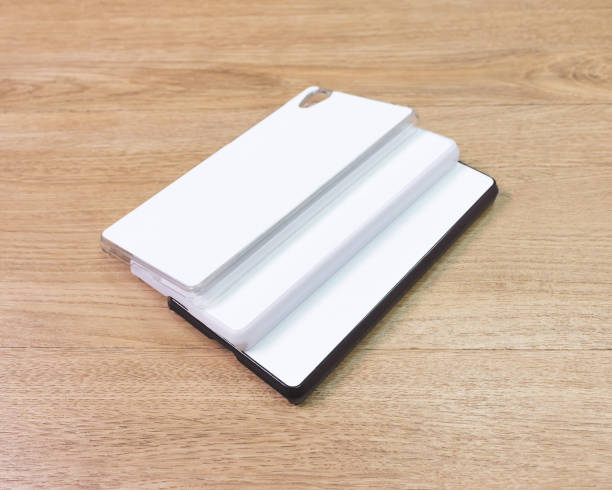 istock White phone cases on wooden background. 671578536