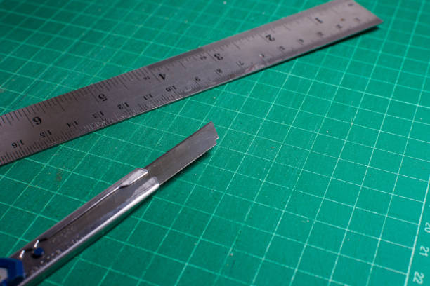 istock Cutter and steel ruler on cutting pad, Office stationery tools. 671578774