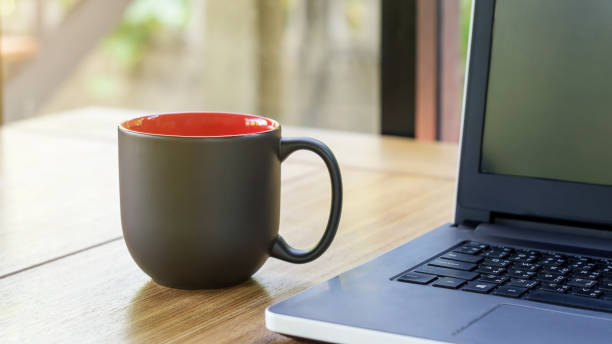 istock The black cup of coffee and laptop. 671585598