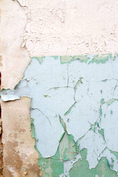 istock Vintage background texture of old brick masonry on ancient cement with cracks with traces of old paint. 671585632