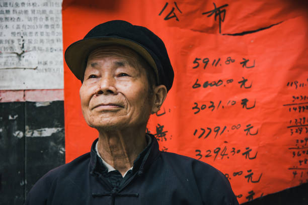 Confident Chinese Senior Man Chengyang China Real People Portrait Chinese senior man looking confident standing outside of small village food store. Chinese Real People Portrait. Chengyang, Sanjiang, Guizhou, China. Unretouched Hand written copyright free background. mao original stock pictures, royalty-free photos & images