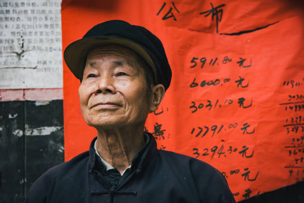 Confident Chinese Senior Man Chengyang China Real People Portrait Chinese senior man looking confident standing outside of small village food store. Chinese Real People Portrait. Chengyang, Sanjiang, Guizhou, China. Unretouched Hand written copyright free background. dong stock pictures, royalty-free photos & images