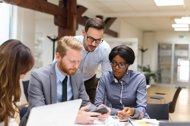 istock Business people using mobile phone during business meeting 671596688