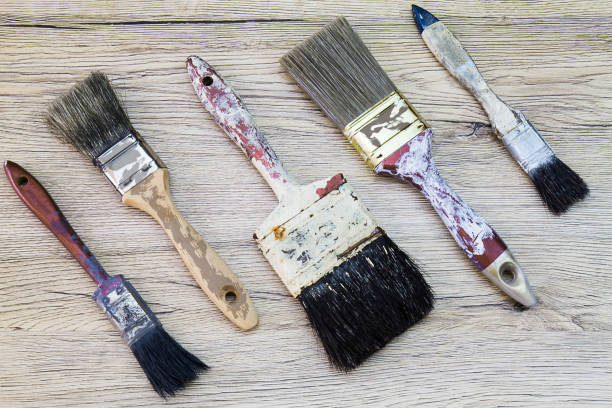 istock Old dirty grunge paintbrushes on dirty rusty wooden background 671598614
