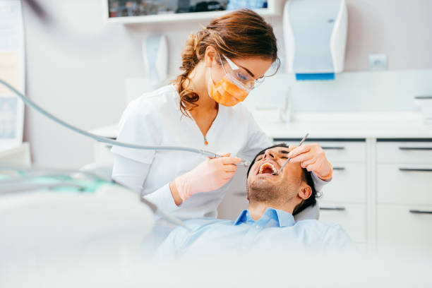Dental cavity removal Female dentist working on patient's teeth. dentist stock pictures, royalty-free photos & images