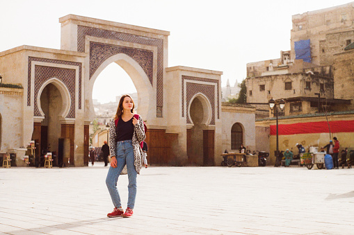 Young Caucasian woman standing near the Bab Boujeloud in Fez, Morocco