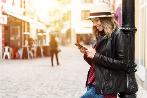 istock Smiling woman with a phone 671605170